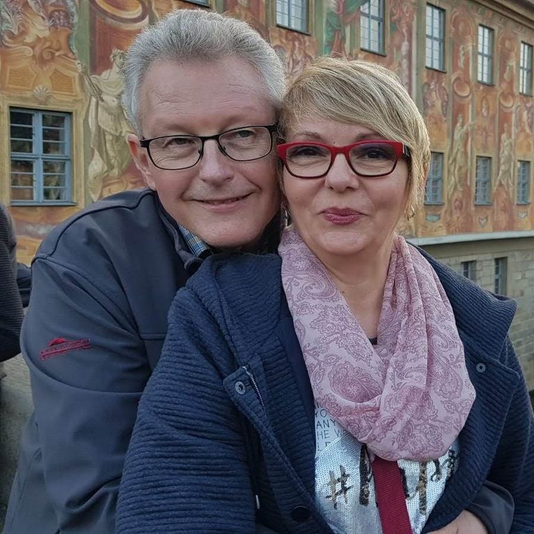 Julianna and Andreas Ott standing in front of a river